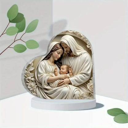 Statue of a religious scene with two figures holding a baby, surrounded by green leaves on a white background.